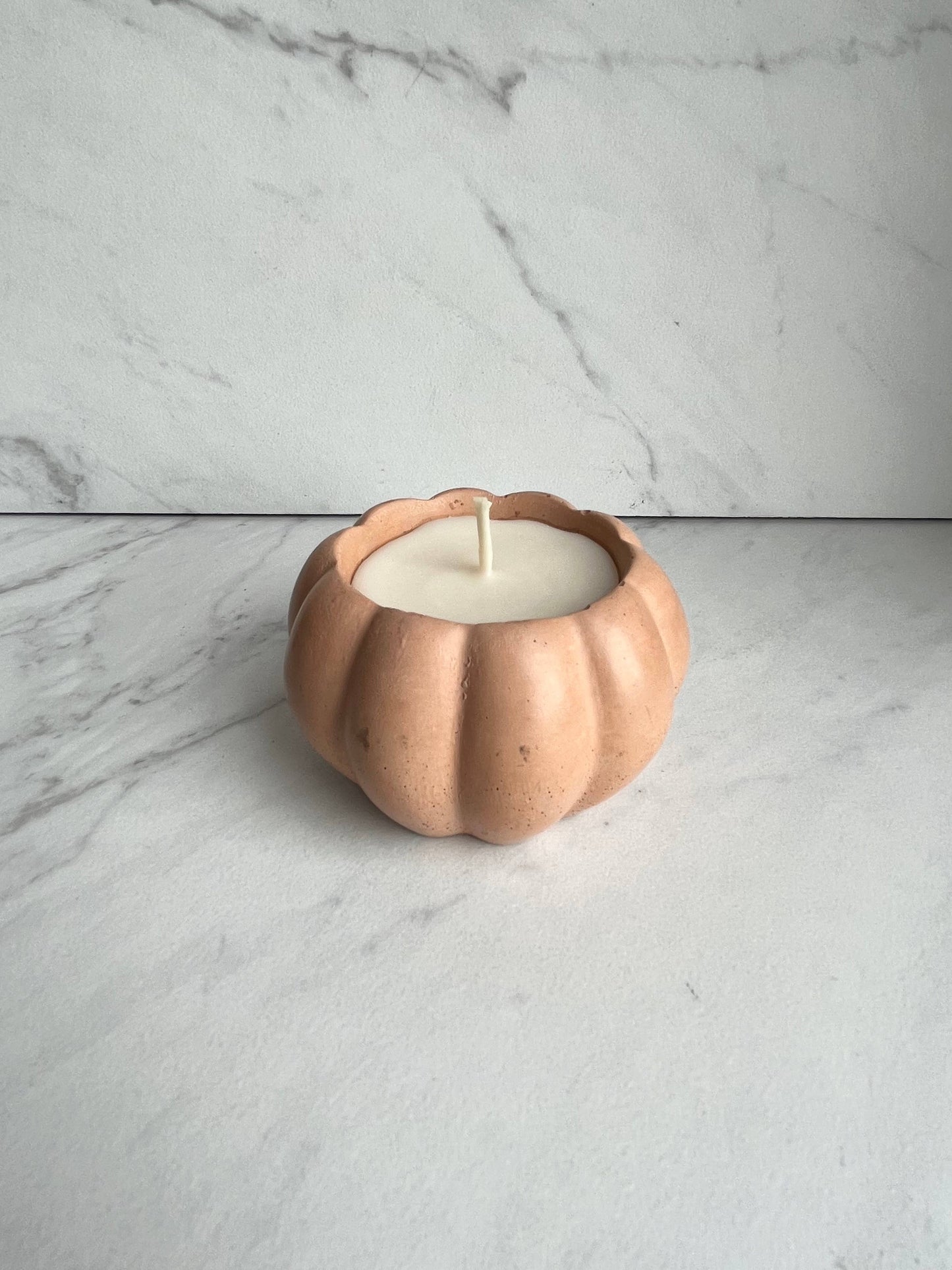 Concrete pumpkin candle