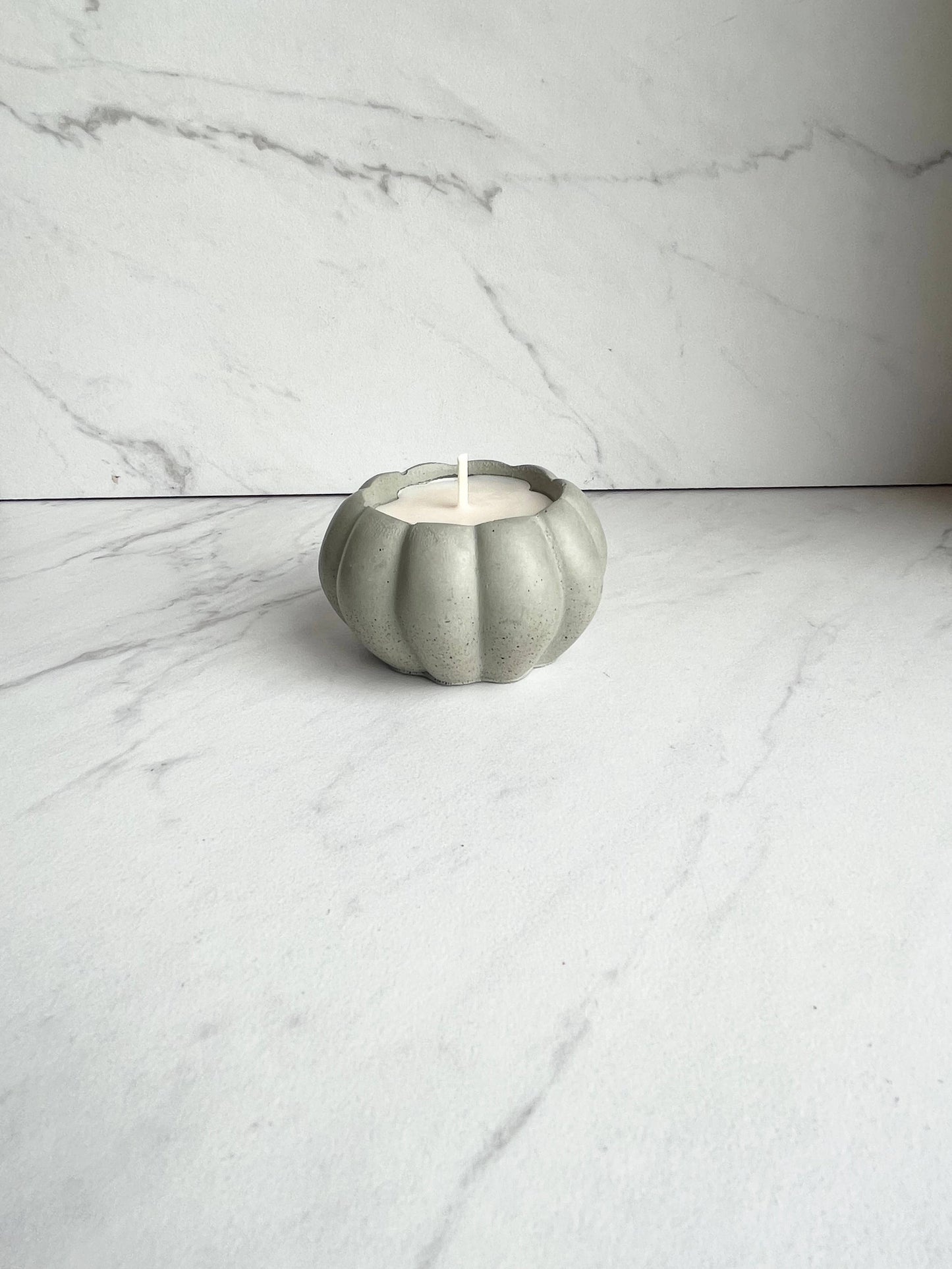 Concrete pumpkin candle